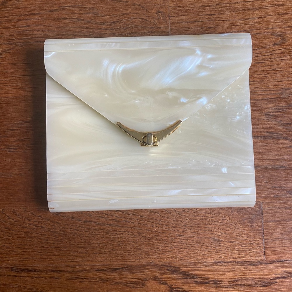 Possible Lucite Cream Clutch with Gold Accent. Hard case.
